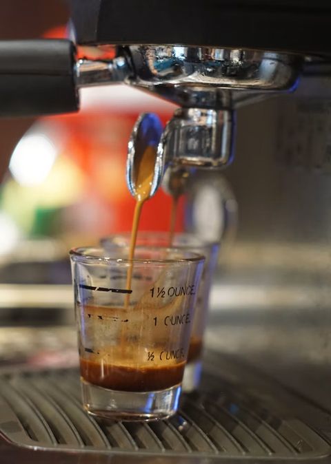 Espresso shot pouring into a measuring glass