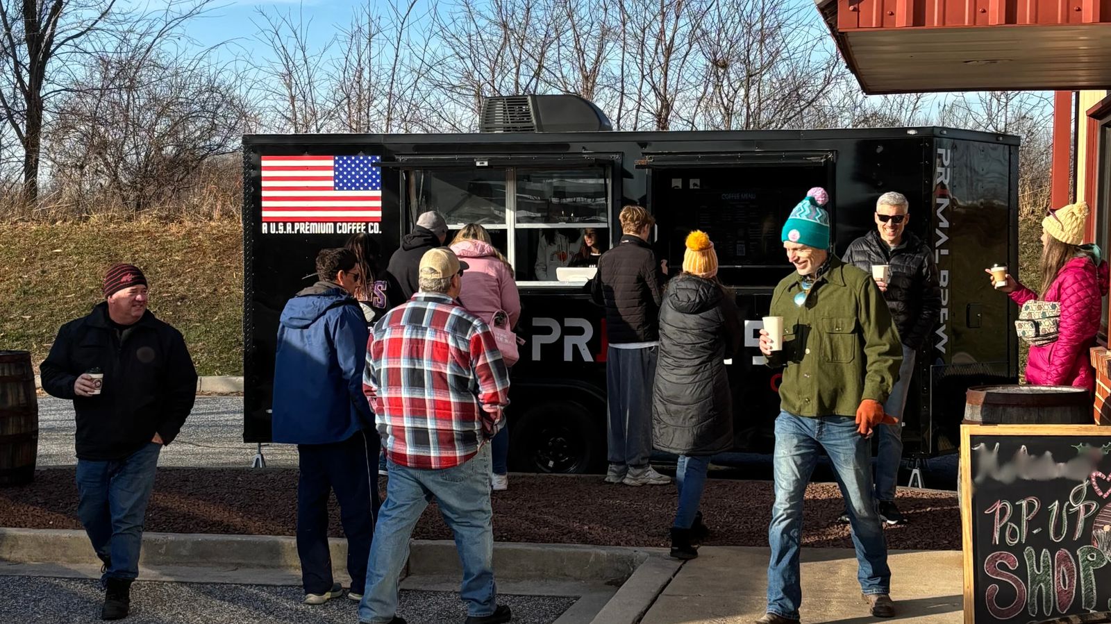 Guests lined up at the Primal Brew mobile coffee trailer at an outdoor event in Maryland